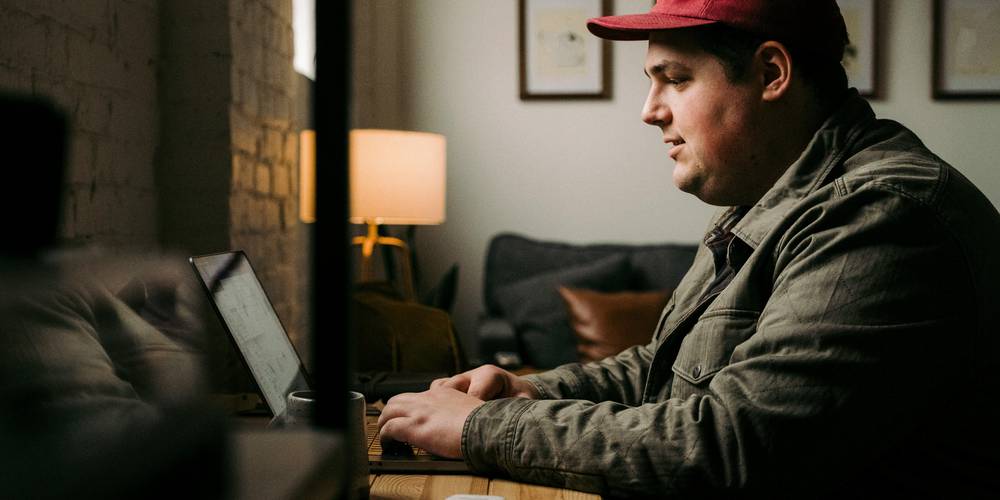 Young renter compares Michigan apartment listings on a laptop
