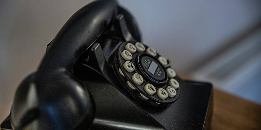Late-night crisis hotline operator connecting a Michigan family to emergency housing resources