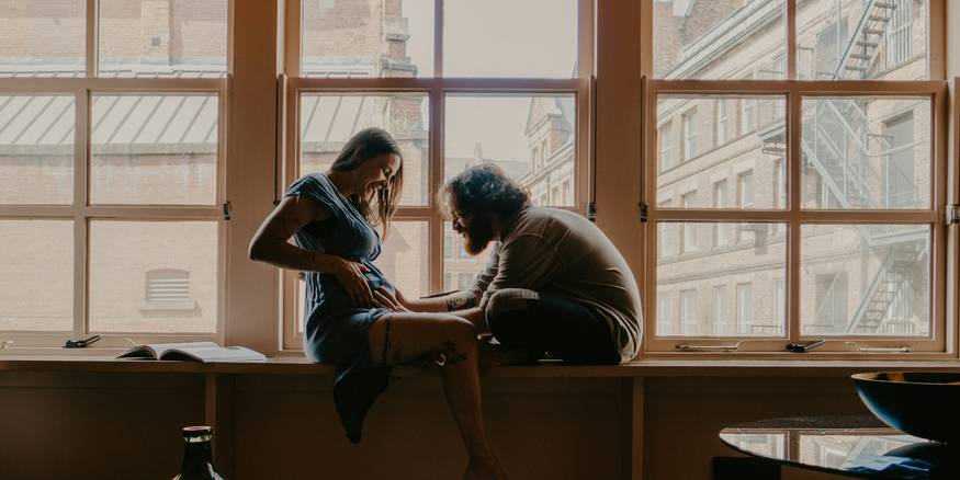 Young couple reviewing a Michigan apartment lease at their kitchen table