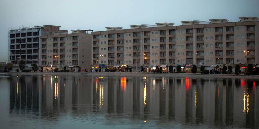 Modern Michigan apartment buildings along the river at dusk