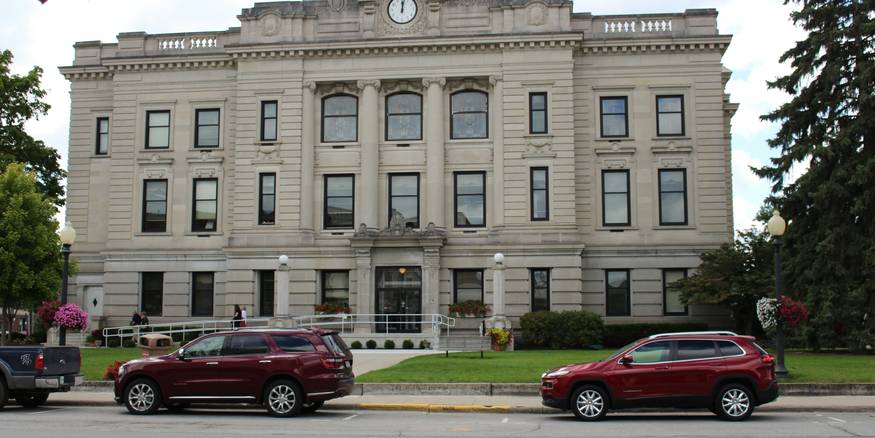 Renter fills out small-claims filing form at a Michigan district courthouse