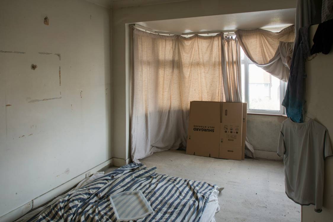 Tenant and landlord perform a walk-through inspection in an empty apartment before move-in