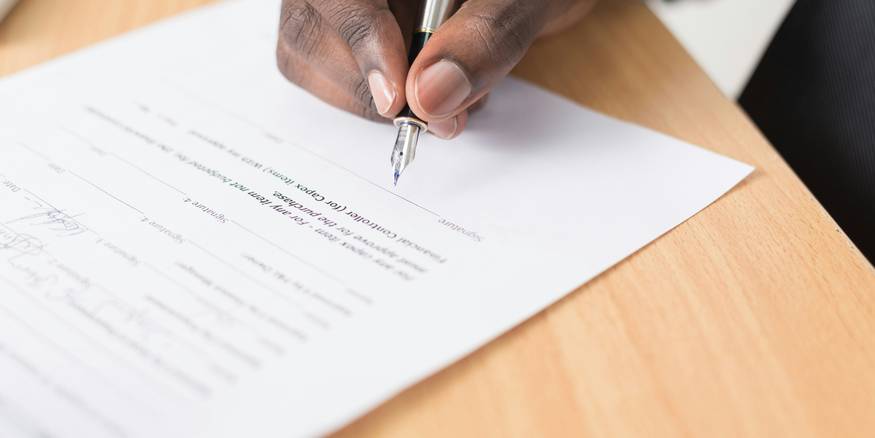 Frustrated Michigan tenant filling out landlord complaint form at a desk
