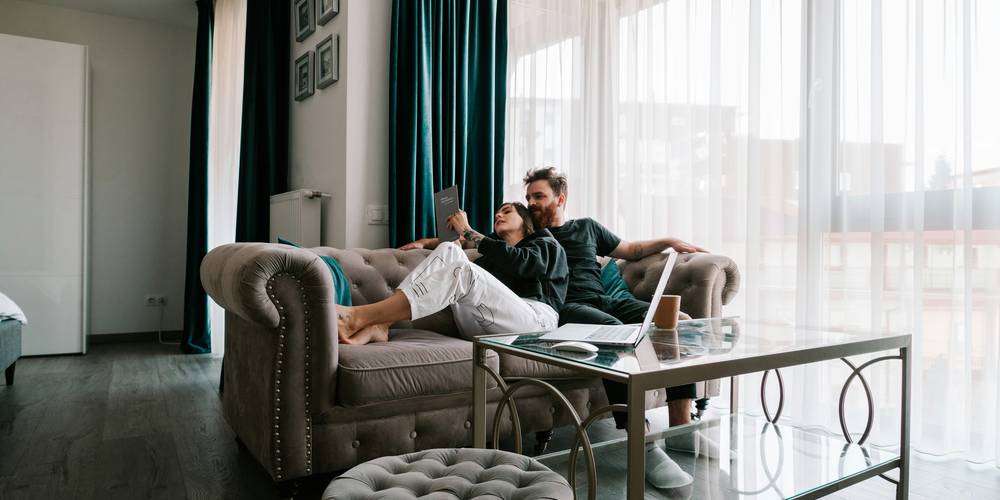 Smiling senior couple reading rental brochure in bright Michigan apartment