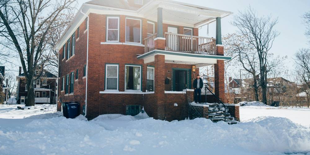 Stressed Michigan renter reviews her apartment lease before deciding whether to break it early