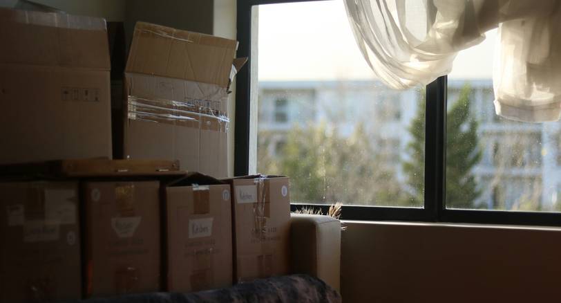 Tenant packs moving boxes after receiving a writ of eviction in Michigan