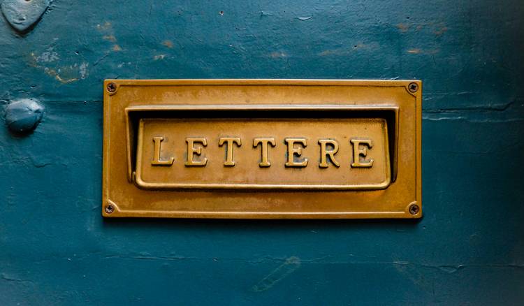 Tenant drafting late-fee dispute letter at desk